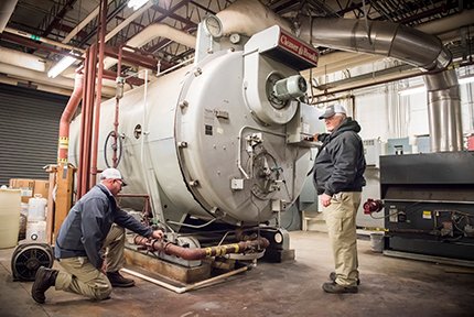 hays employee inspecting a large system