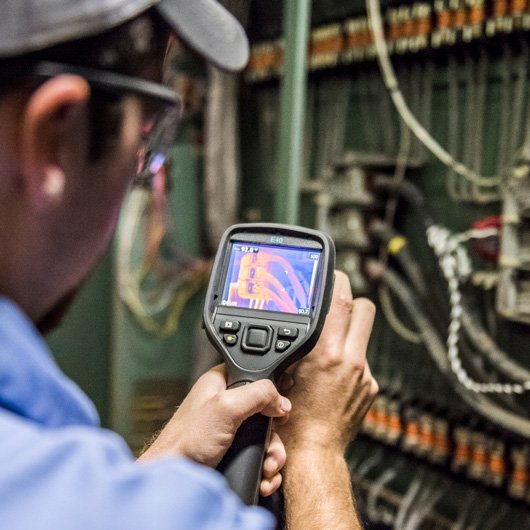 hays employee using tool to inspect